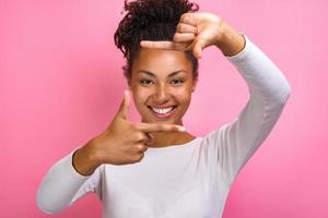 Closeup portrait of a funny girl makes a gesture square from fingers - Image photo