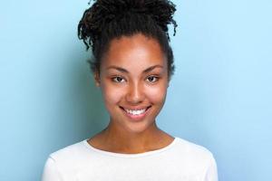 Closeup portrait of a charming girl over blue studio background- Image photo