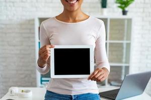 Imagen de maqueta de primer plano de la pantalla en blanco vacía negra de la tableta en la mano femenina, imagen recortada