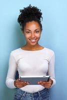 Happy woman standing with ipad looking at the camera and happily smile closeup photo