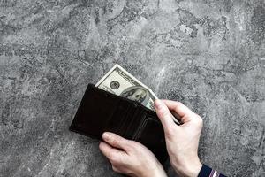 Man taking out  money from her pocket wallet top view photo