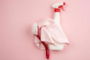 on a pink background cloth, brush for cleaning, spray. Items for ordering photo