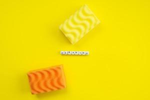 Yellow and orange washcloth on yellow background. Copy space. photo