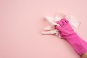 Hand in latex gloves and cloth on a horizontal surface photo