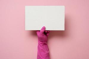 On a pink background, cleaning gloves, place for writing text, copy space photo