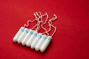 Tampons isolated on red background. Concept women sanitary protect photo