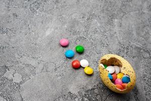 Easter Eggs with sweets over gray background photo