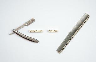 Razor and comb on a white background. Barber tool close-up. photo