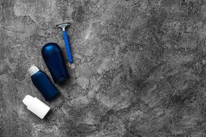 Men's care products are laid out on a gray background photo