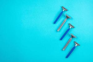 Blue disposable razors isolated on blue background photo