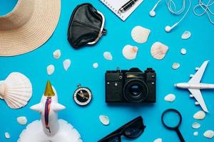 Top view of travel accessories set on blue background photo