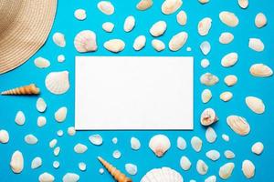 Seashells with copy space for text on blue paper background. Top view Template for your design. photo