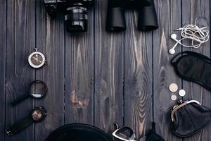 Outfit of traveler on wooden background photo