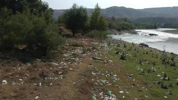 garbaged riverside - trash on river shore video