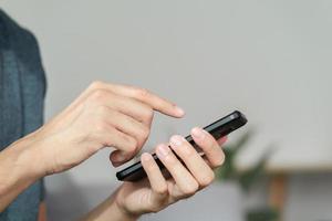 Closeup of happy man using a smartphone , searching, browsing, social media, message, email, internet digital marketing, online shopping. photo