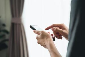 Closeup of happy man using a smartphone , searching, browsing, social media, message, email, internet digital marketing, online shopping. photo