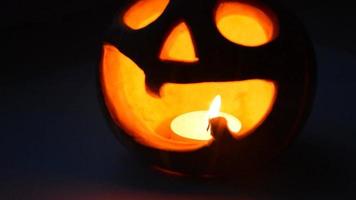 Lighted pumpkin-shaped candle for halloween burning