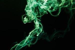 Smoke floating on dark background photo