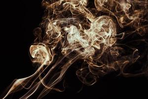 Smoke floating on dark background photo