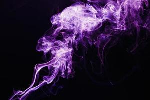 Smoke floating on dark background photo