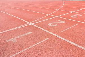 Numbered running track in stadium photo