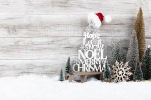 Christmas tree on wooden background. photo