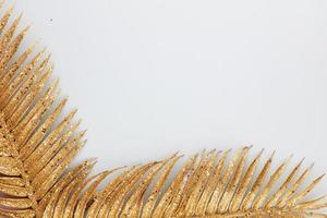 Palm gold leaf on blue background. Palm leaf, Flat lay and top view. photo