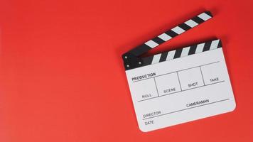 Clapperboard or movie slate. it use in video production ,film, cinema industry on red background. photo