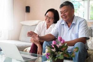 Grandpa and Grandma were a video call on laptop to say hello. photo