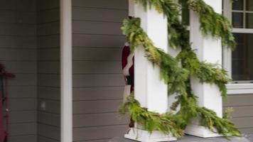 Santa Claus going into front door of home