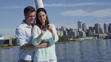 Young couple on sailboat together using cell phone. Shot on RED EPIC for high quality 4K, UHD, Ultra HD resolution. video