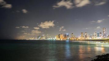 Seascape and skyscrapers on background at night in Tel Aviv, Israel. photo