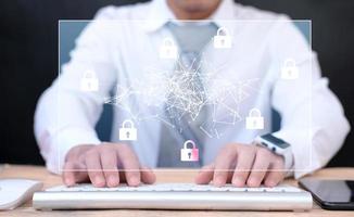 Businessman working on table with digital cyber security photo