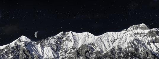 chain of mountains in winter in the night photo