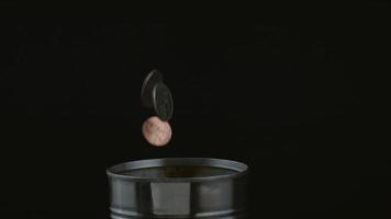 Coins dropping into can in slow motion shot on Phantom Flex 4K at 1000 fps video