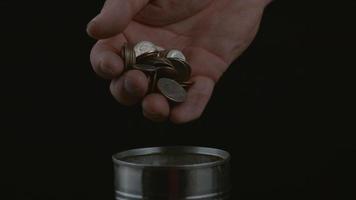 Hand dropping coins into can in slow motion shot on Phantom Flex 4K at 1000 fps video
