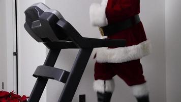 Santa Claus running on treadmill in gym video
