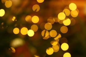 Long exposure blurred yellow christmas tree lights abstract background photo