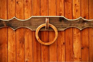 Wooden entrance gate with round knocker handle photo