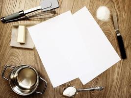 Blank copy paper sheets on wooden table with baking tools and ingredients photo