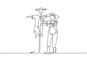 Single continuous line drawing a young female farmer in a straw hat putting up scarecrow to keep out pests of birds. Farming minimalist concept. One line draw graphic design vector illustration.