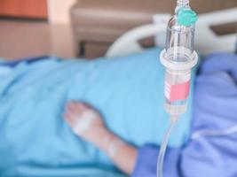 Patient in hospital with saline intravenous IV, saline into the body for treatment photo