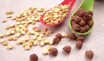 Black Chickpeas or Kala Chana with chana dal pulse isolated on wooden Background. photo