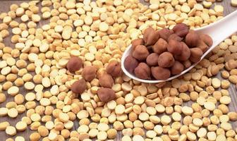 Black Chickpeas or Kala Chana with chana dal pulse isolated on wooden Background. photo