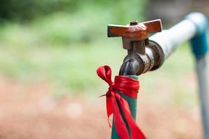 Hoses that connect to the faucet with an old connector at the back of the house photo