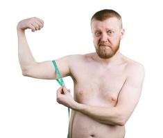 Bearded man measures the size of your biceps photo