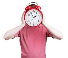 Man in a pink shirt with an alarm clock photo