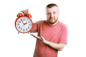 Man with a red alarm clock in his hand photo