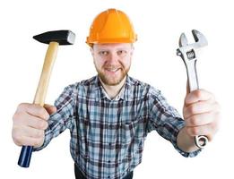 Man in the helmet with a hammer, wrench photo