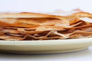 Stack of pancakes lies on a plate photo